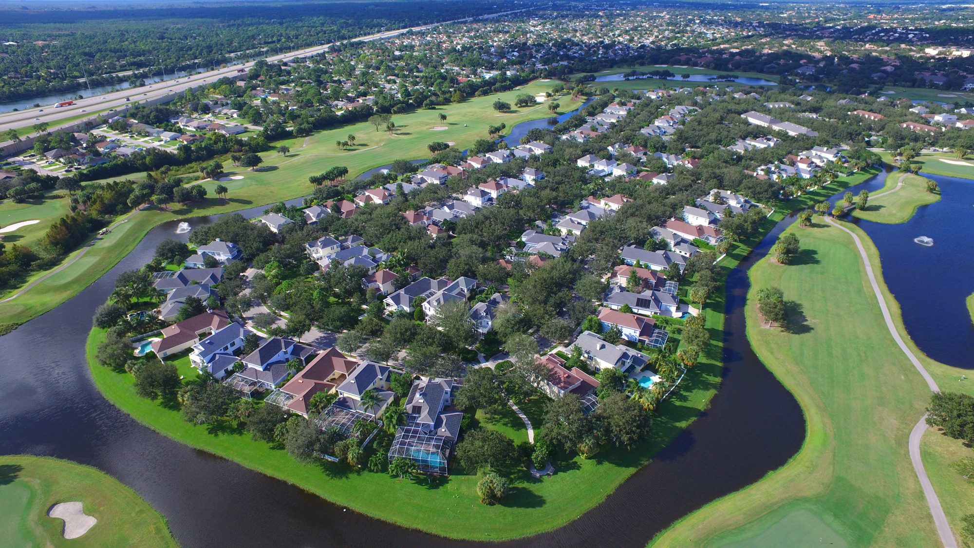 Abacoa homes on a tree-lined peninsula between golf holes and water