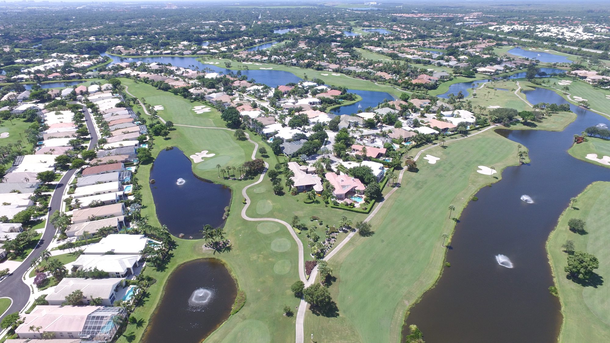 BallenIsles fairway along a lake lined with homes