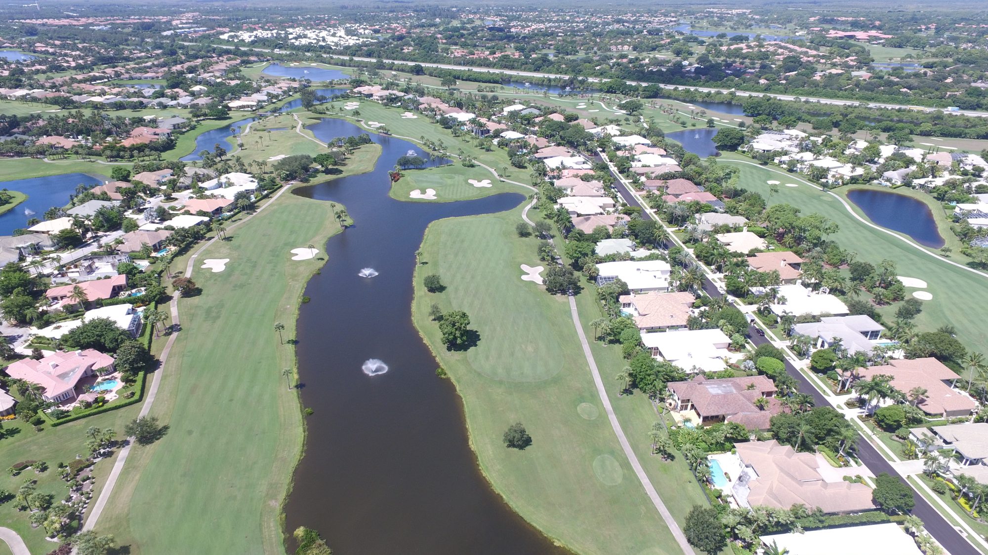 BallenIsles homes between the golf course and a lake