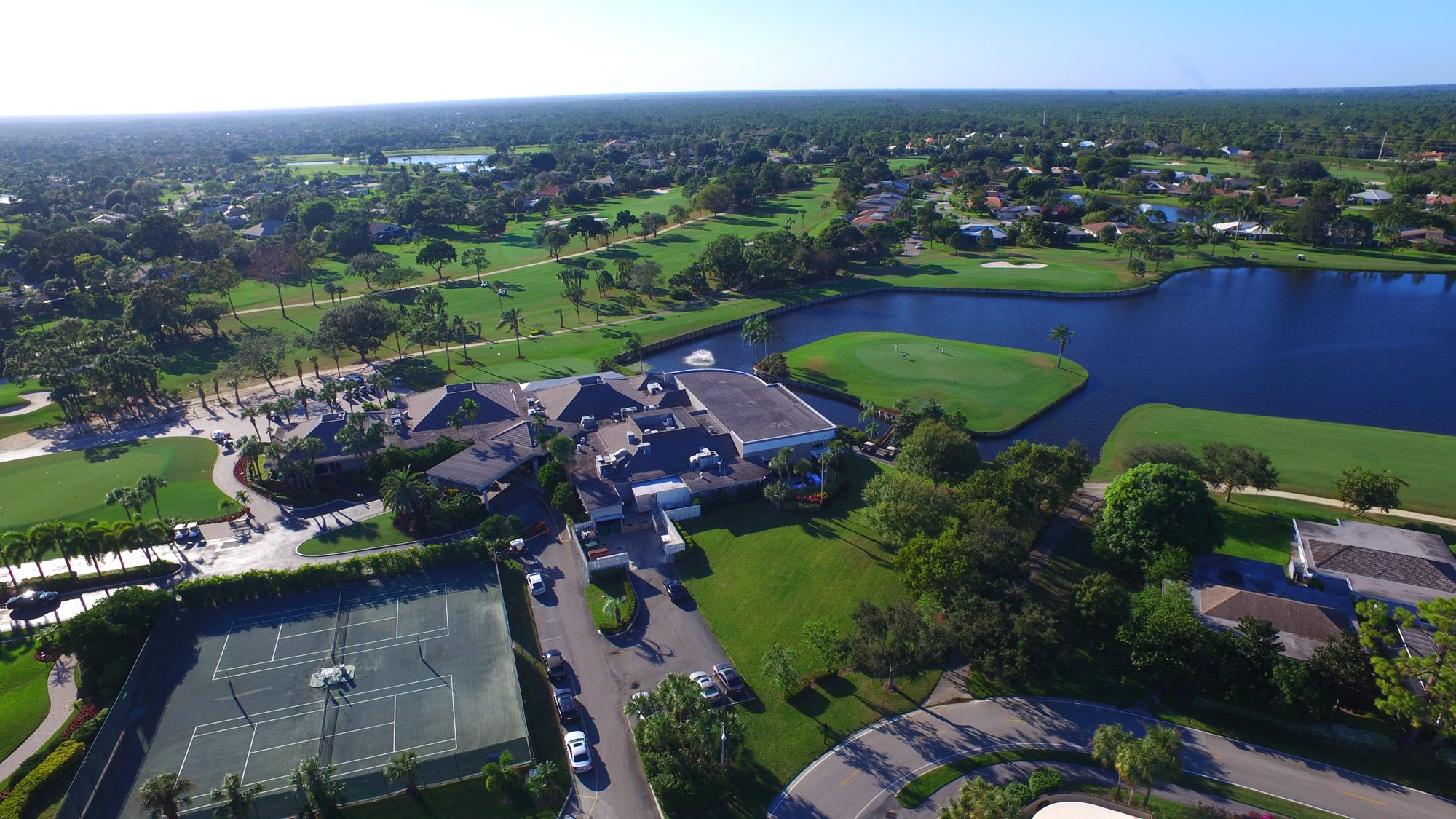 The East Point clubhouse and pool beside the practice greens