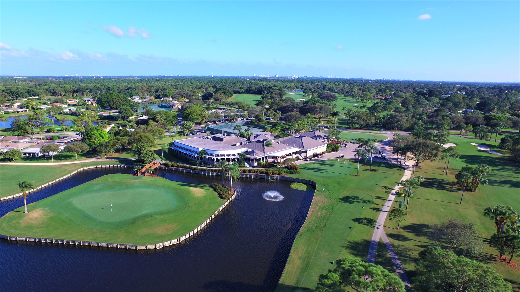 East Point fairways, bunkers and a lakeside green with homes beyond