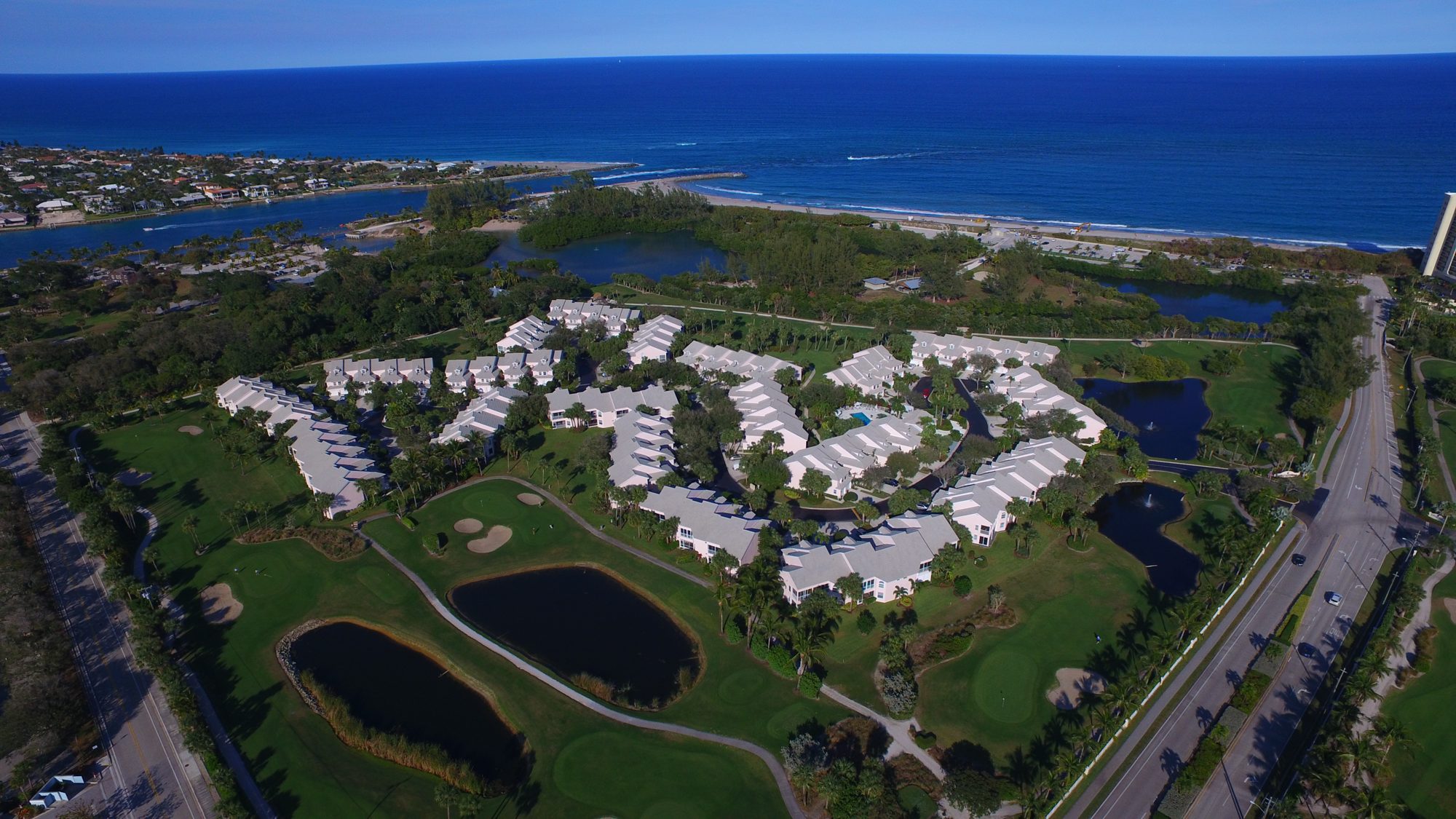 Jupiter Dunes fairways and lake with the ocean in the distance