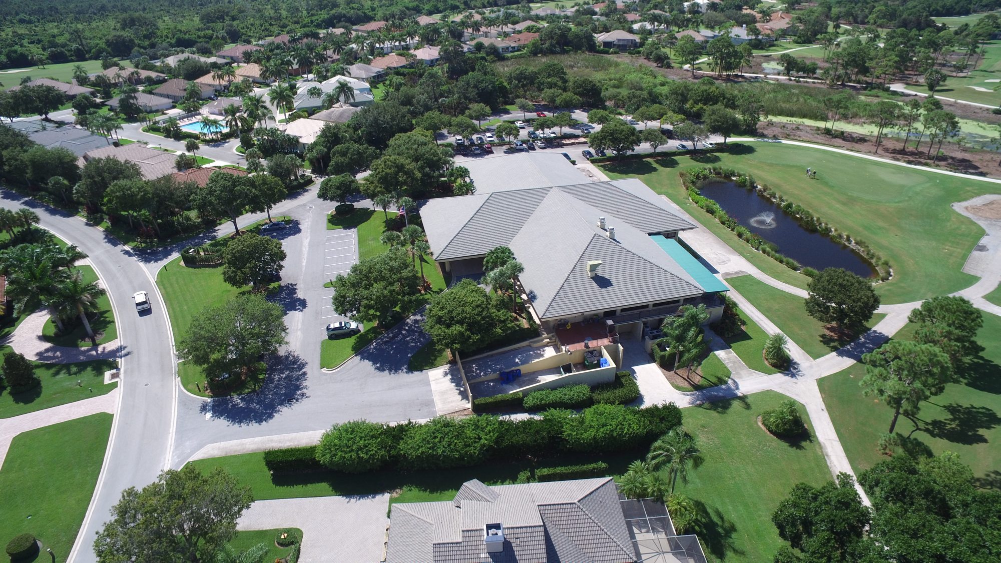 The clubhouse, course and homes with the ocean on the horizon