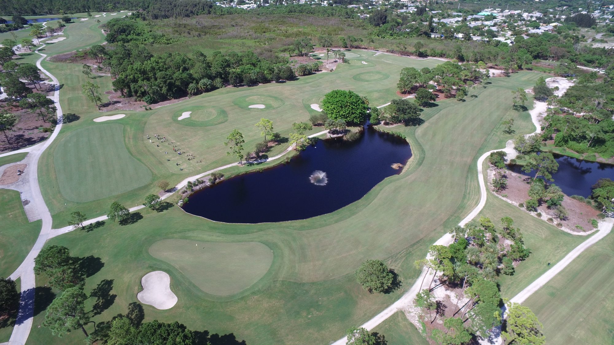 The practice range and a green beside a fountain lake