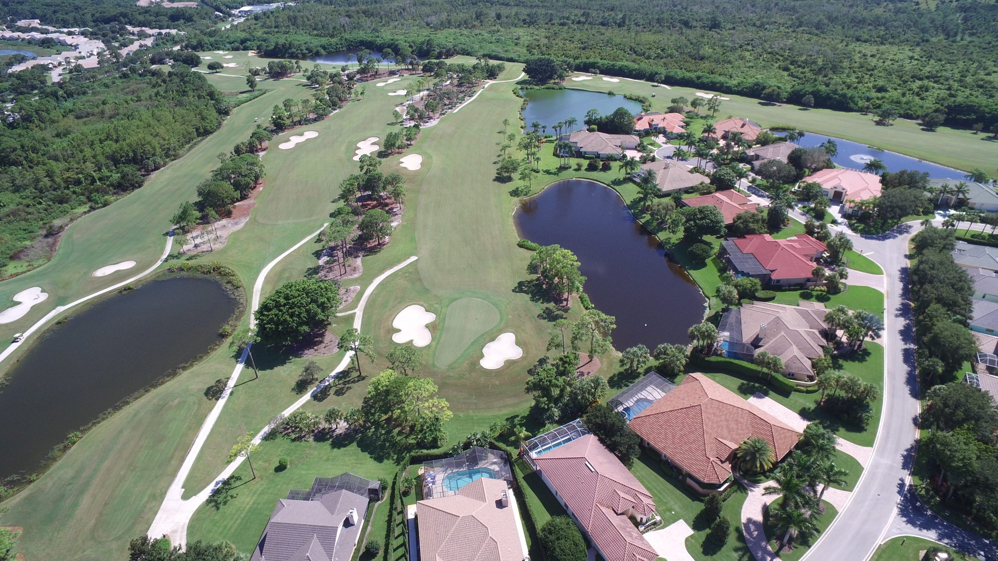 Homes along a lake beside a Hobe Sound Golf Club fairway