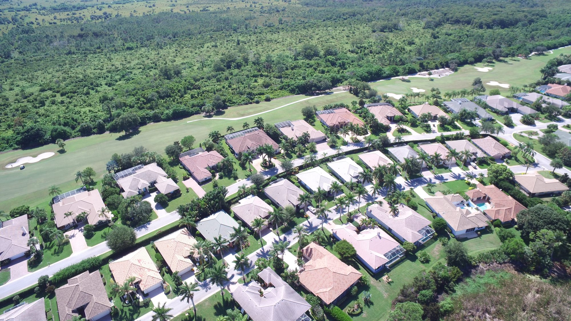 Hobe Sound Golf Club homes along a fairway bordered by preserve