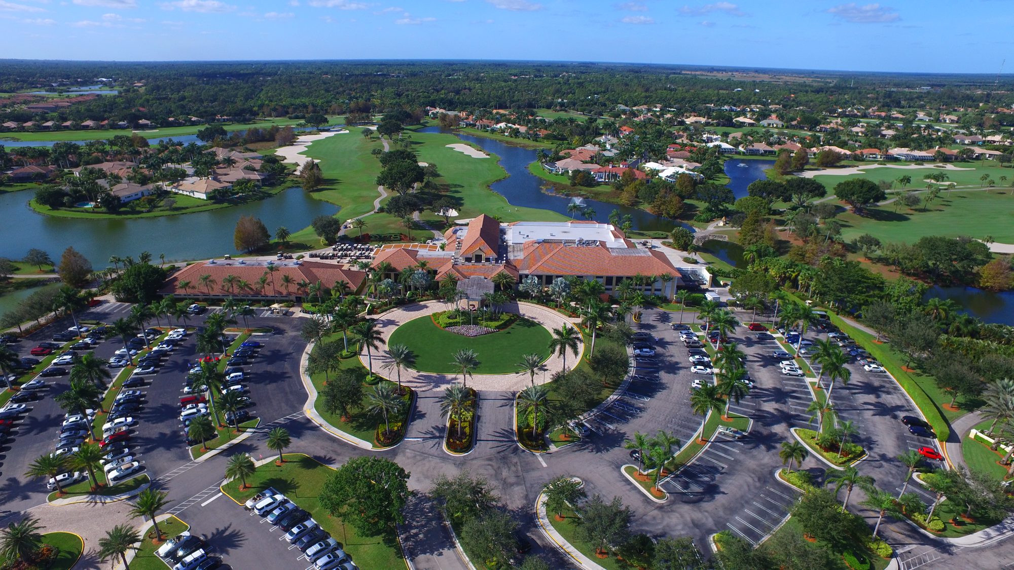 The Ibis clubhouse entry circle with golf and lakes beyond
