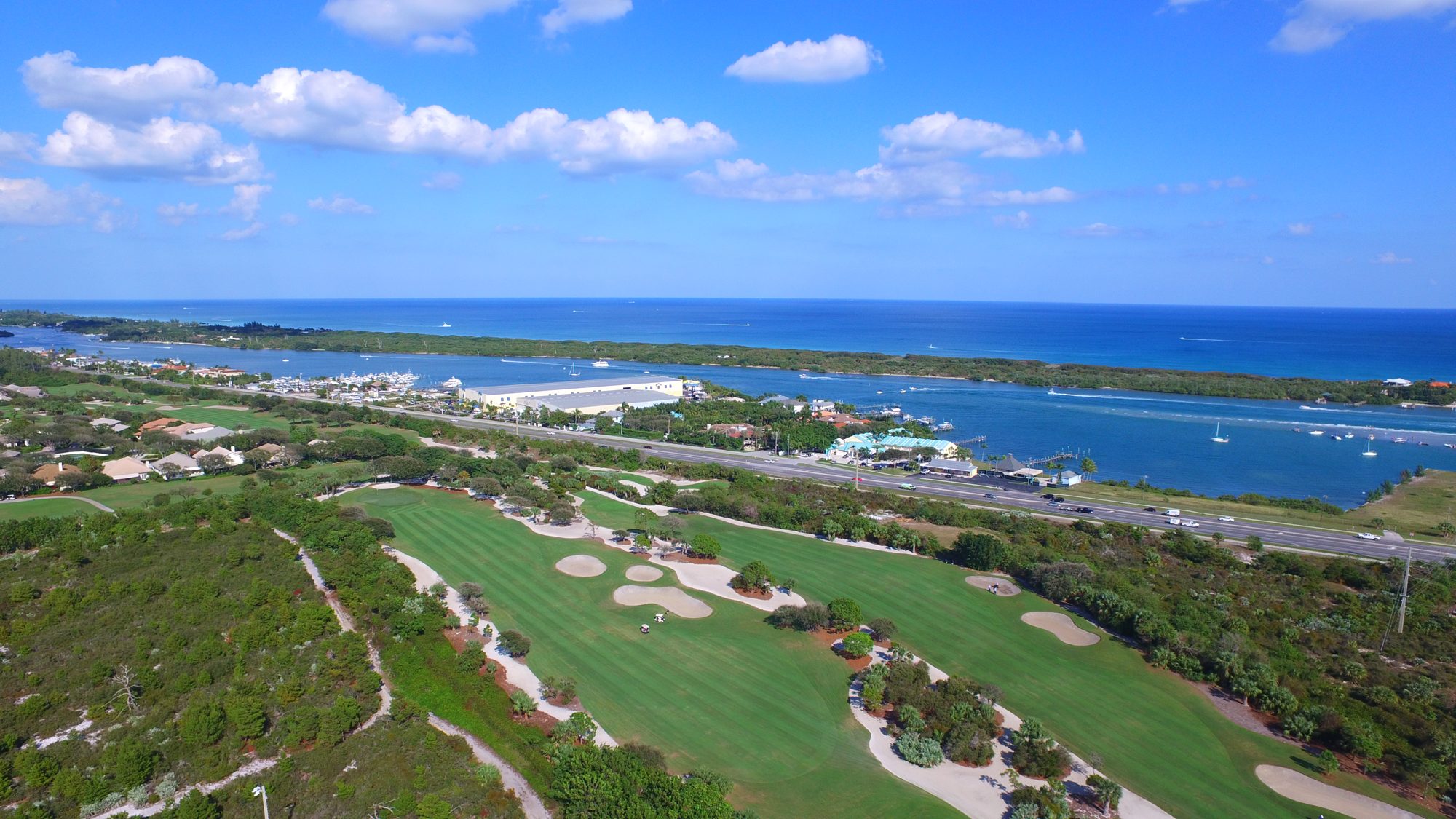 Jupiter Hills greens, bunkers and sandy waste areas beside a lake