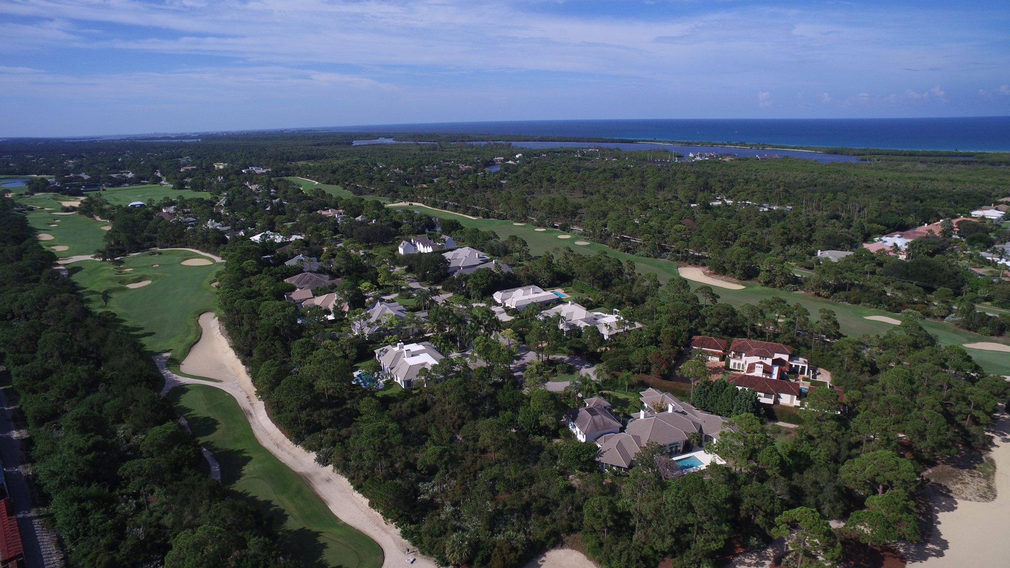 Loblolly homes around a fairway lined with sandy waste areas
