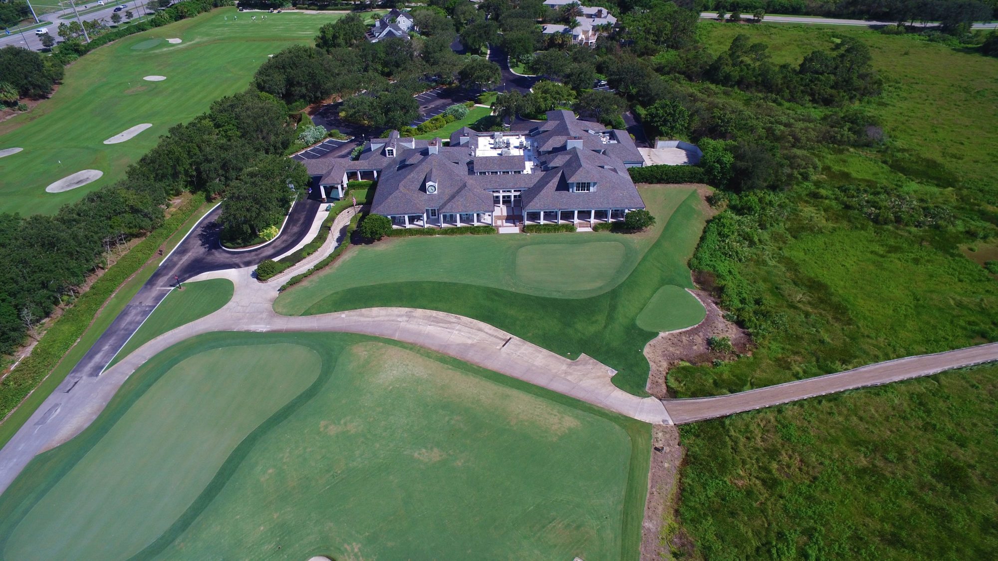 The Medalist clubhouse and putting green in early light