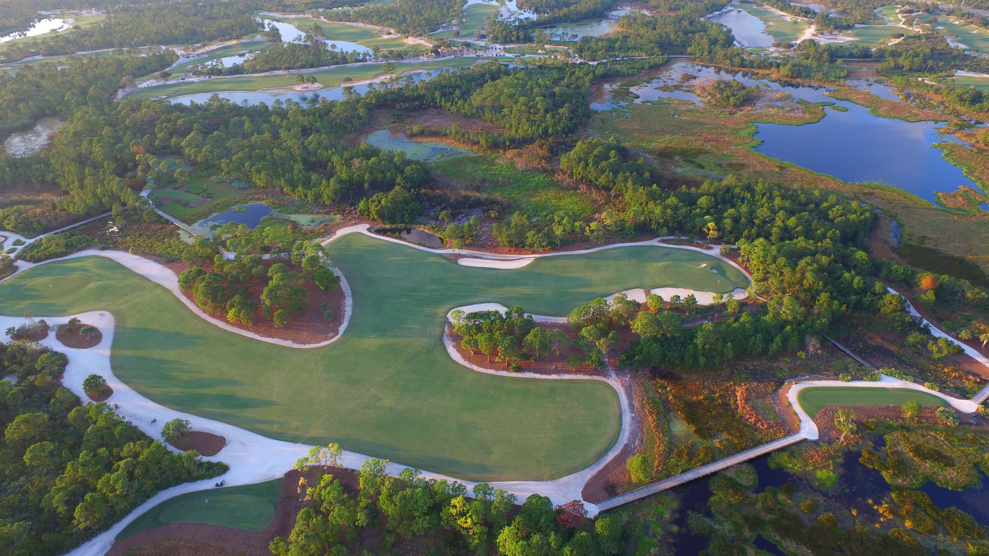 A long boardwalk crossing the wetlands between Medalist holes