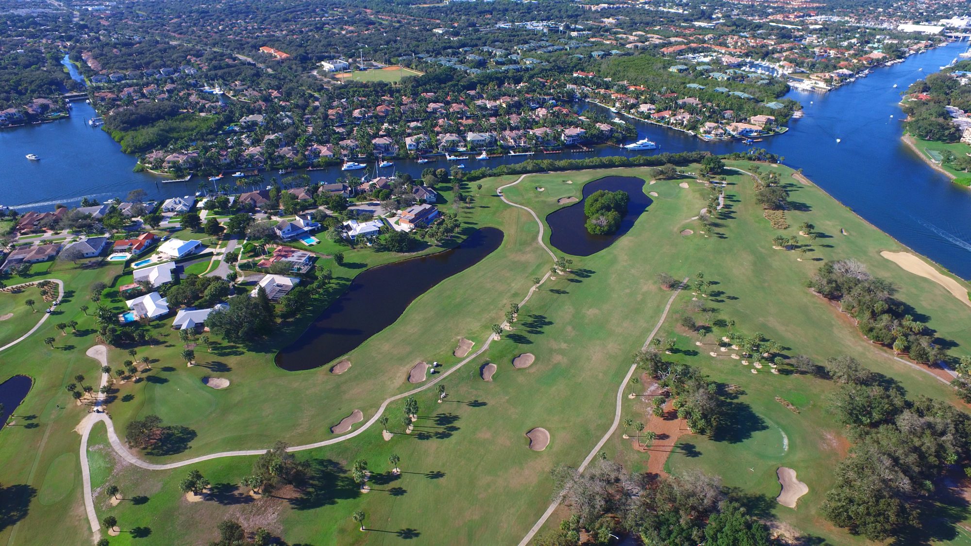 The clubhouse and pool beside the course and neighborhood homes