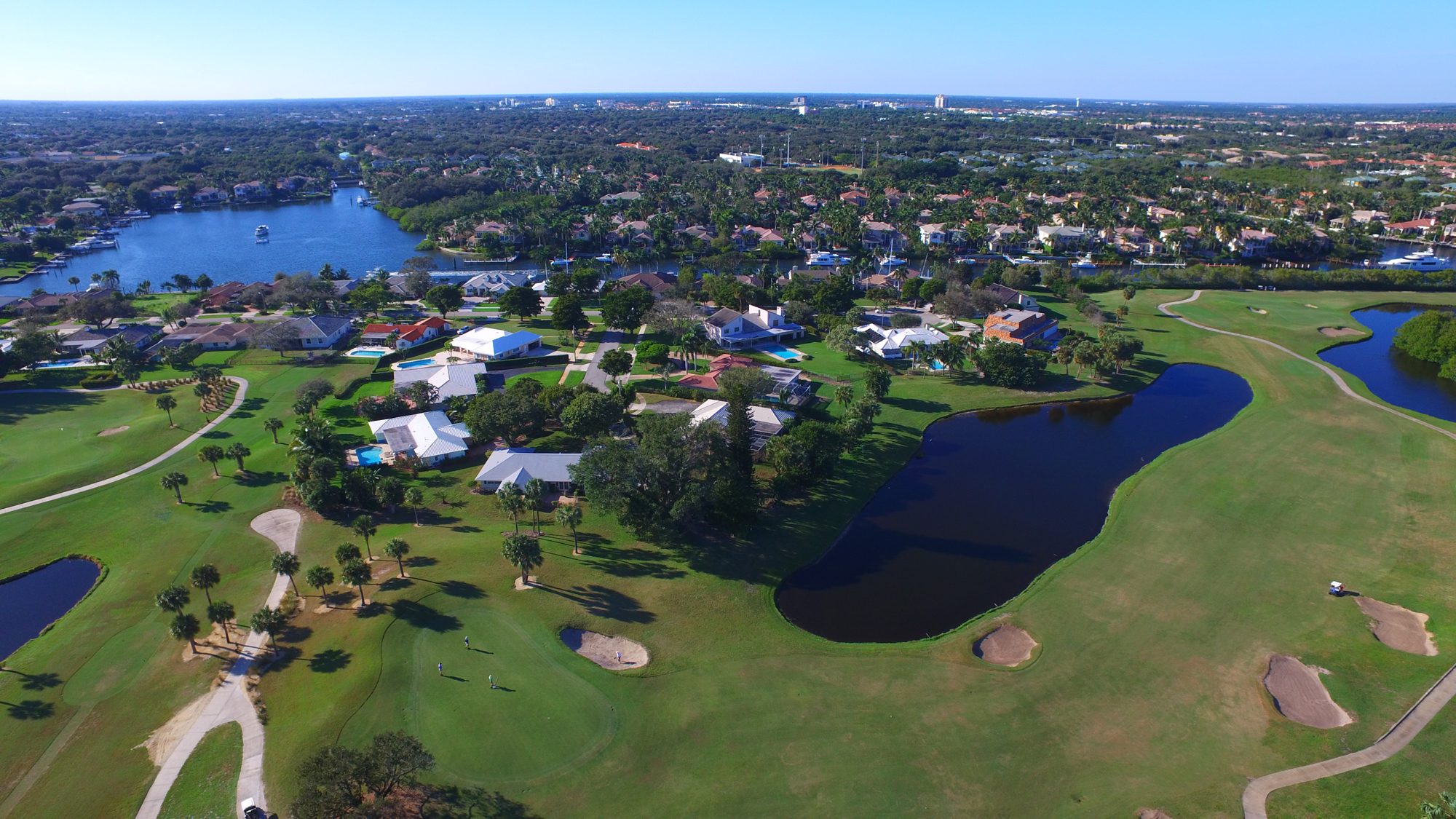 Homes along a lake and green at North Palm Beach Country Club