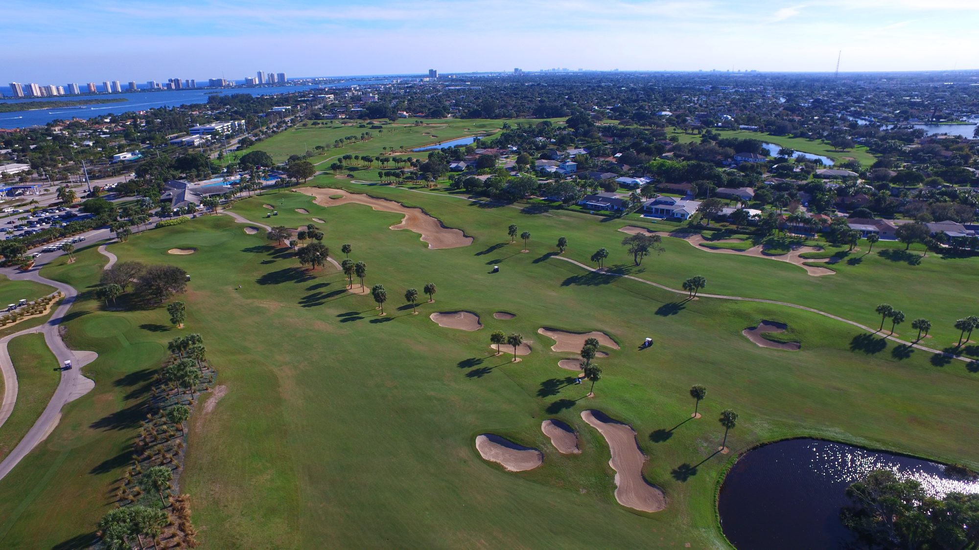 North Palm Beach Country Club fairways and bunkers with the clubhouse and Singer Island beyond