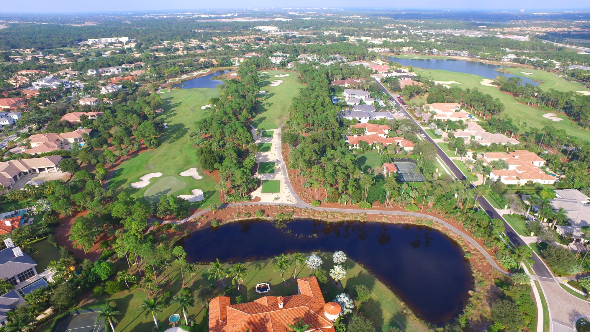 The Old Palm clubhouse above the finishing greens and the island Bye Hole
