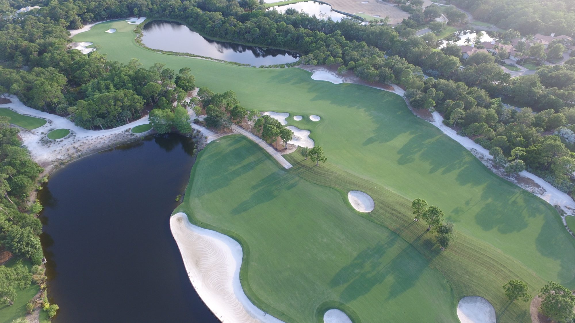 Two Bears Club holes framed by sand, pines and a lake